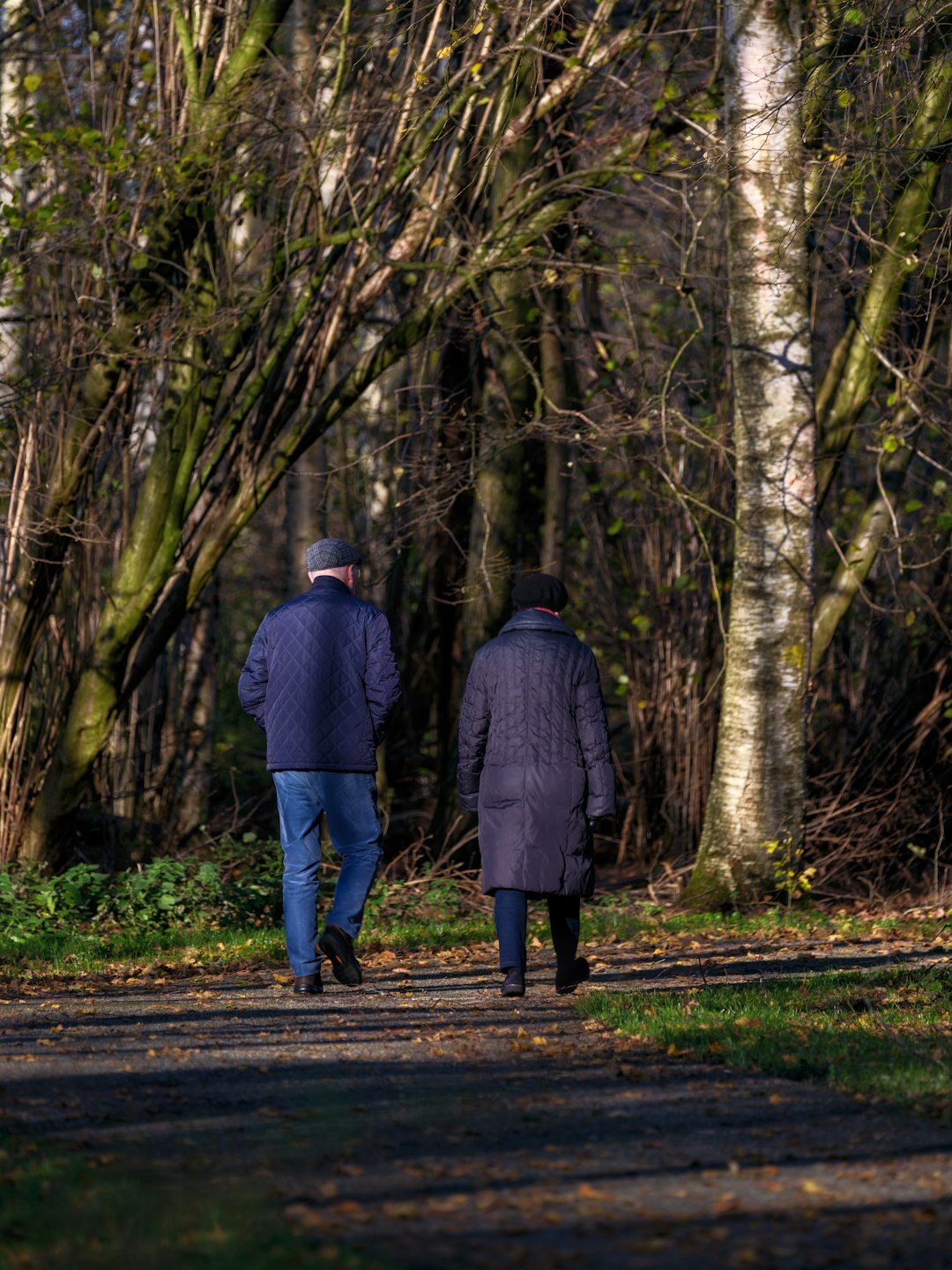 elderly couple walking in park