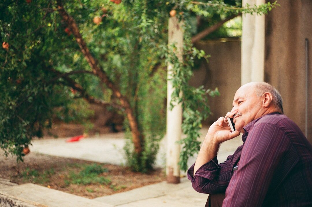 Croatian senior man smiling while talking on the phone